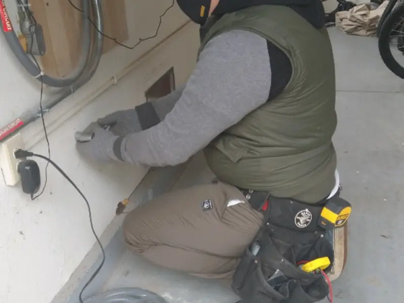 Electrician performing outlet wiring in a Josephine garage